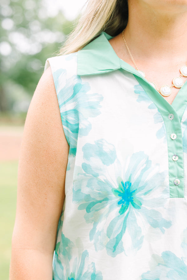 Plus Size sleeveless white dress with green floral print, a collared neckline, and button placket.