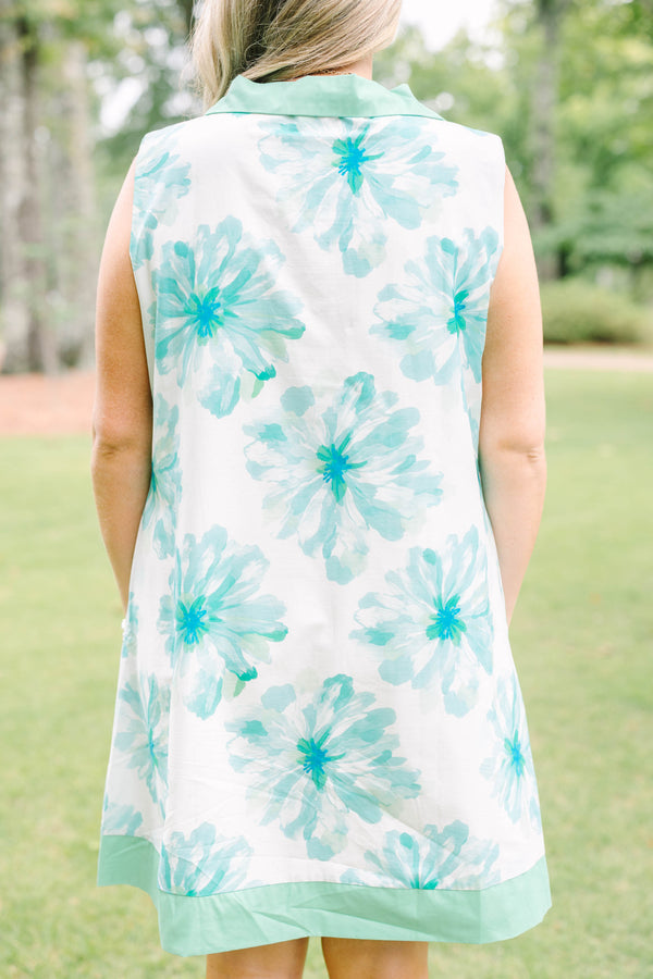 Plus Size sleeveless white dress with green floral print, a collared neckline, and button placket.