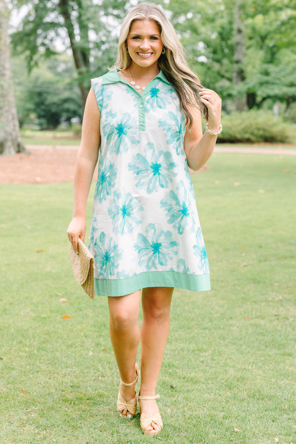 Plus Size sleeveless white dress with green floral print, a collared neckline, and button placket.