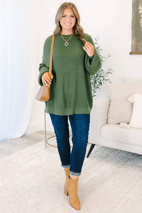 Plus size olive green oversized knit sweater with a relaxed fit and crew neckline.