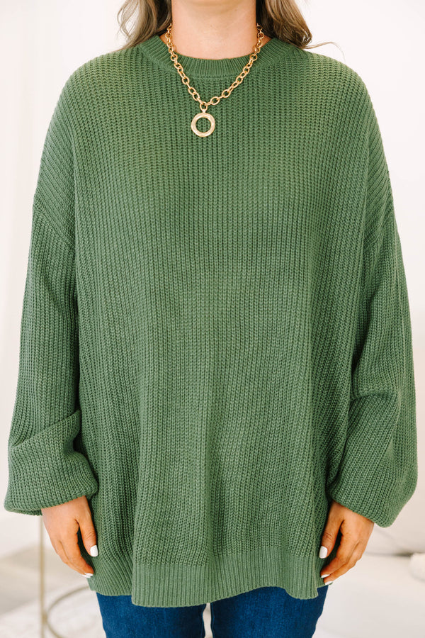 Plus size olive green oversized knit sweater with a relaxed fit and crew neckline.