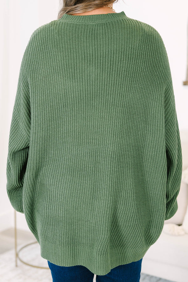 Plus size olive green oversized knit sweater with a relaxed fit and crew neckline.