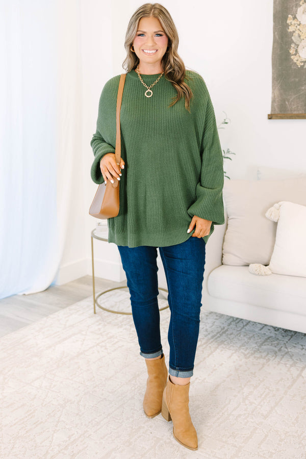 Plus size olive green oversized knit sweater with a relaxed fit and crew neckline.