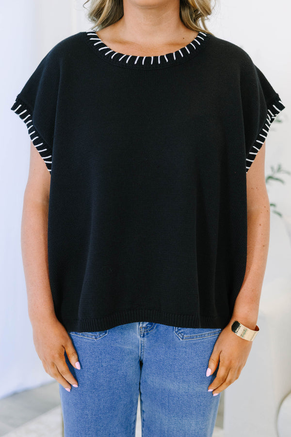 Plus Size black short sleeve knit top with white whipstitch detailing on the neckline and sleeves.