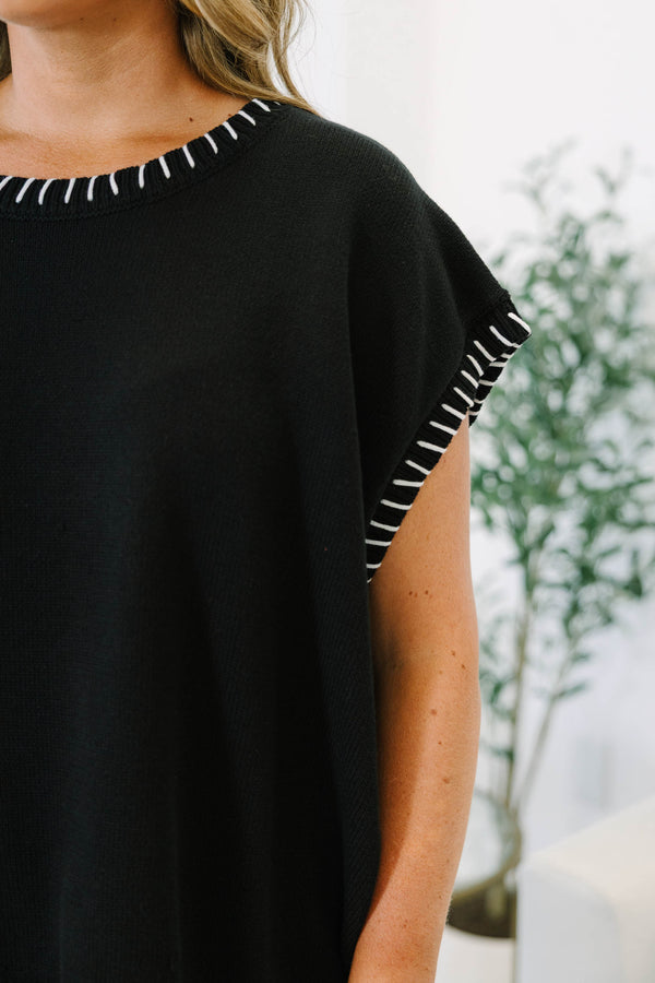 Plus Size black short sleeve knit top with white whipstitch detailing on the neckline and sleeves.