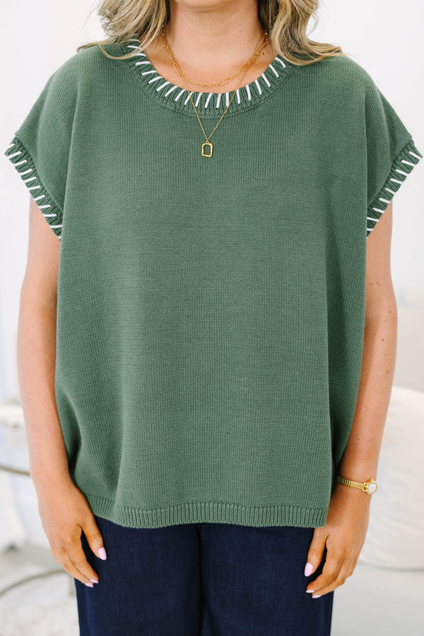 Plus Size green knit short sleeve top with white whipstitch detailing on the neckline and armholes.