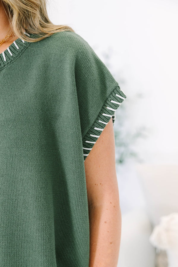 Plus Size green knit short sleeve top with white whipstitch detailing on the neckline and armholes.