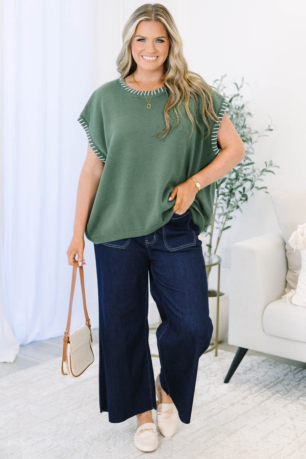 Plus Size green knit short sleeve top with white whipstitch detailing on the neckline and armholes.