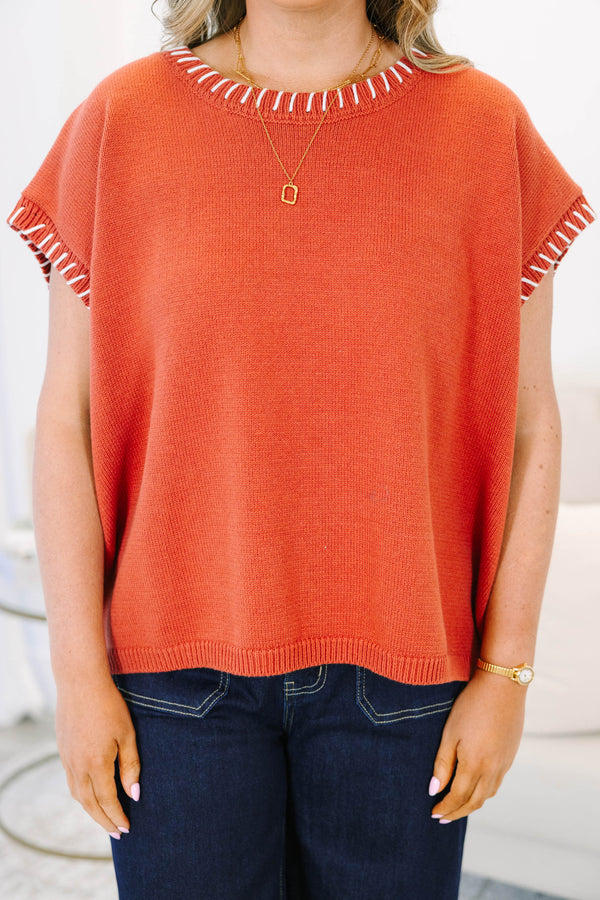 Plus Size rust knit top with white whipstitch trim on the crew neckline and short sleeves.