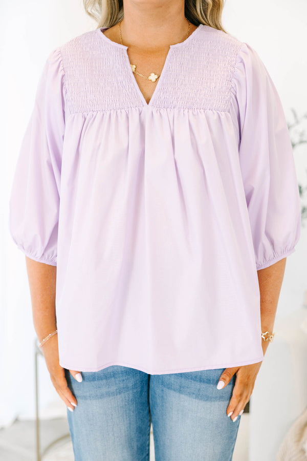 Plus Size lavender top with a split v-neck, smocked yoke, and three-quarter puff sleeves.