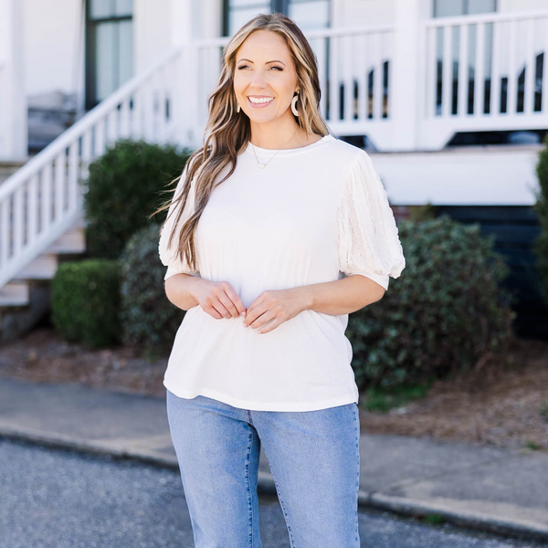 Plus Size off white top with a round neckline and textured mesh bubble sleeves.