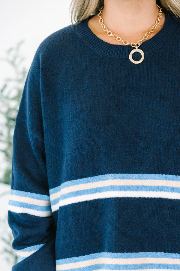 Plus Size navy blue crewneck sweater with horizontal light blue and white stripes and long sleeves.