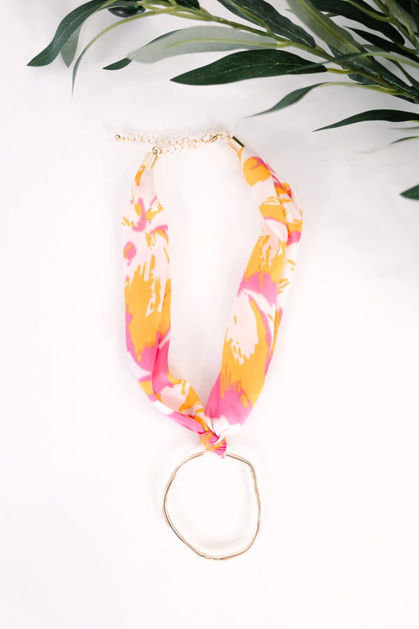 Plus Size pink and orange abstract floral print fabric scarf necklace with a gold ring pendant.