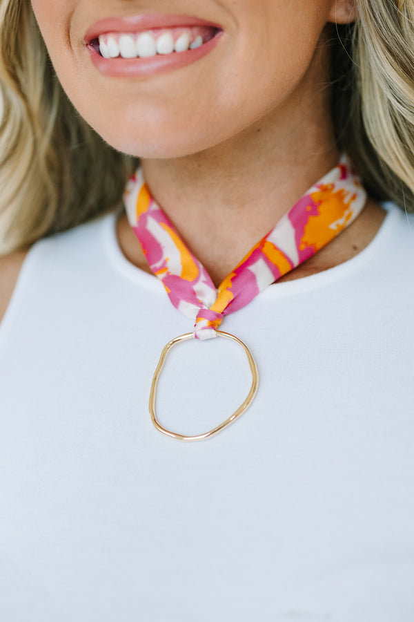 Plus Size pink and orange abstract floral print fabric scarf necklace with a gold ring pendant.