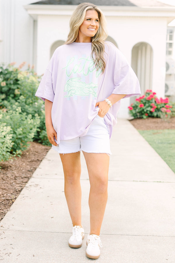 Plus Size lilac oversized boyfriend tee with a green alligator graphic and white denim shorts.