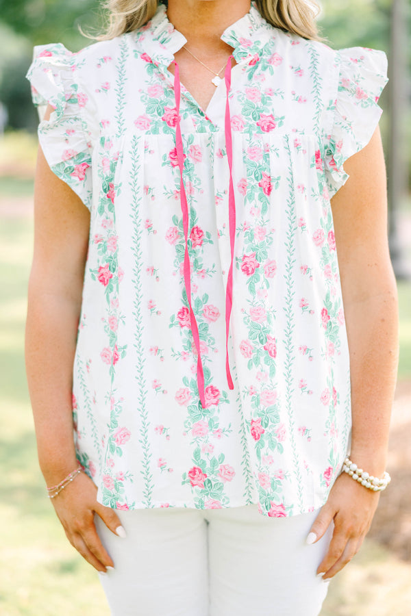 Plus Size white floral top with pink rose print, ruffle sleeves, and pink tie neckline.