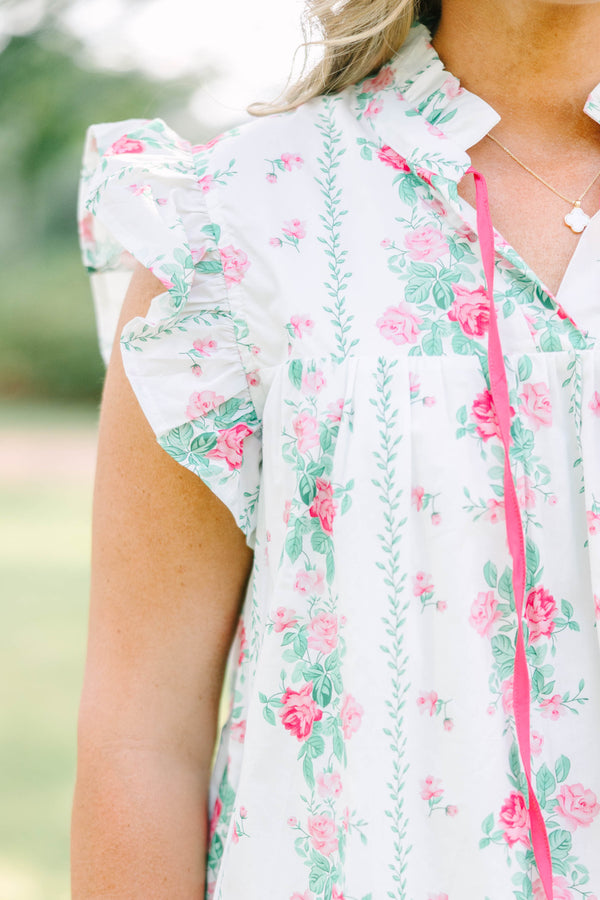 Plus Size white floral top with pink rose print, ruffle sleeves, and pink tie neckline.