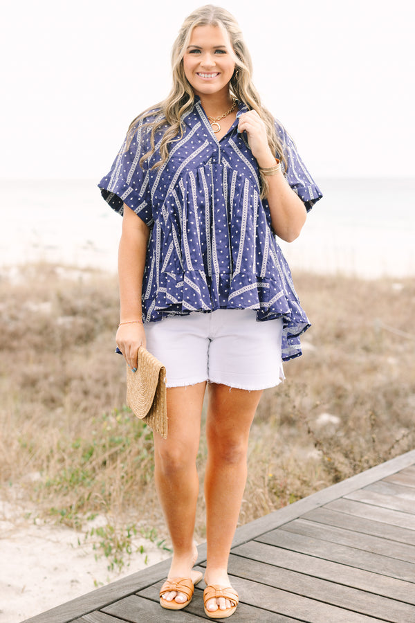 Chic Soul plus size clothing, navy short sleeve flowy top with white embroidered detailing pattern and v neck cutout and ruffle high low hem