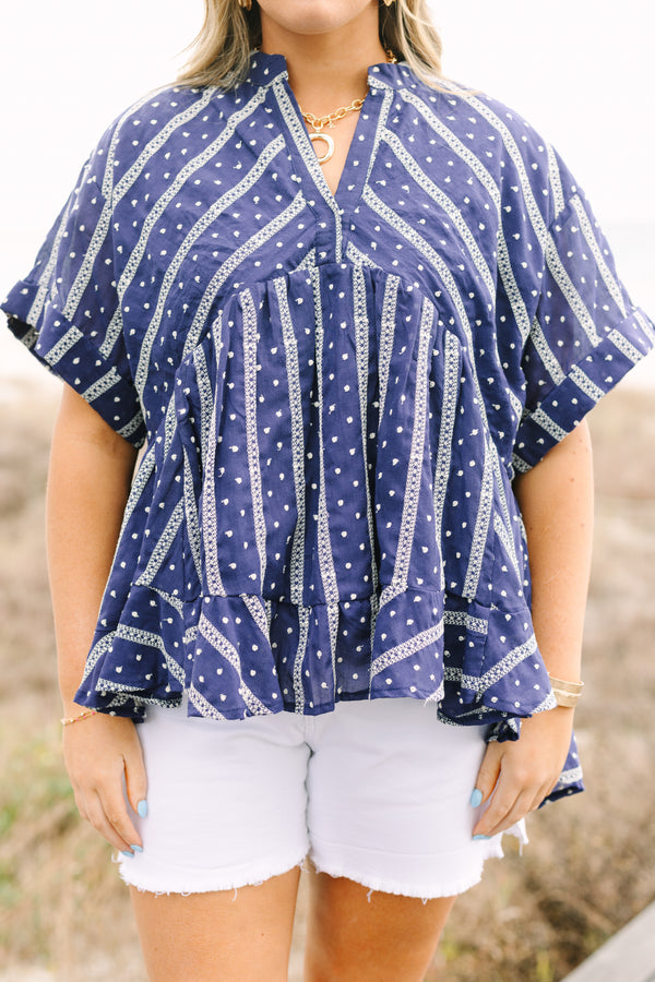 Chic Soul plus size clothing, navy short sleeve flowy top with white embroidered detailing pattern and v neck cutout and ruffle high low hem