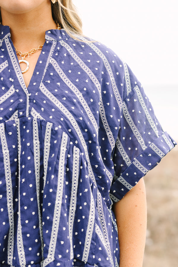 Chic Soul plus size clothing, navy short sleeve flowy top with white embroidered detailing pattern and v neck cutout and ruffle high low hem