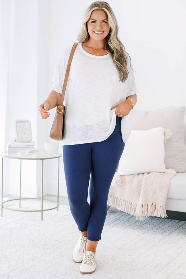 Plus size navy blue high-waisted leggings with a cropped fit and stretchy fabric.