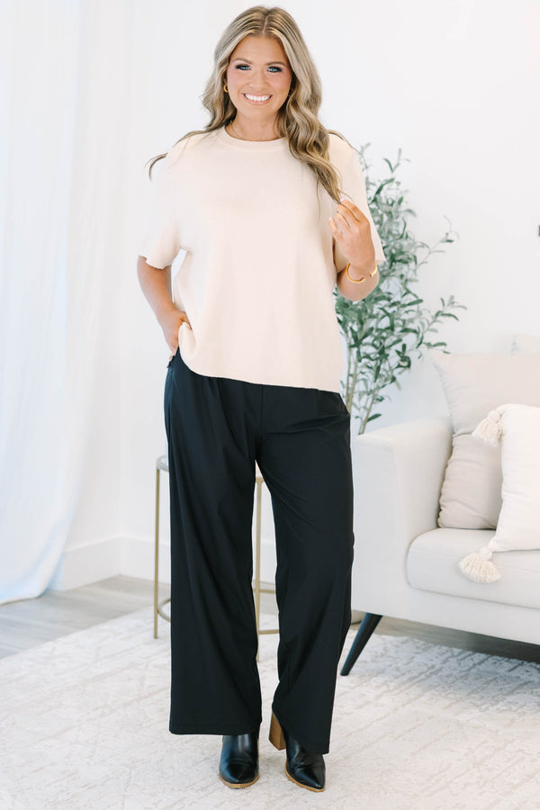 Plus size black wide-leg pants with a flowy fit and comfortable elastic waistband.