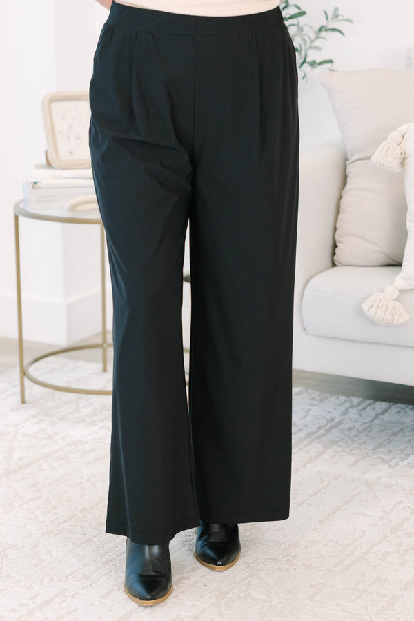 Plus size black wide-leg pants with a flowy fit and comfortable elastic waistband.