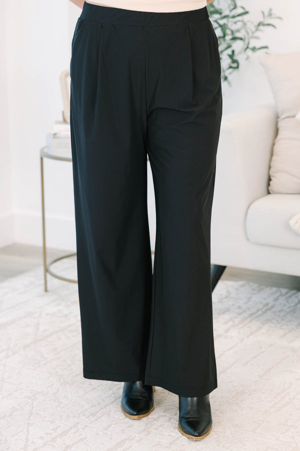 Plus size black wide-leg pants with a flowy fit and comfortable elastic waistband.