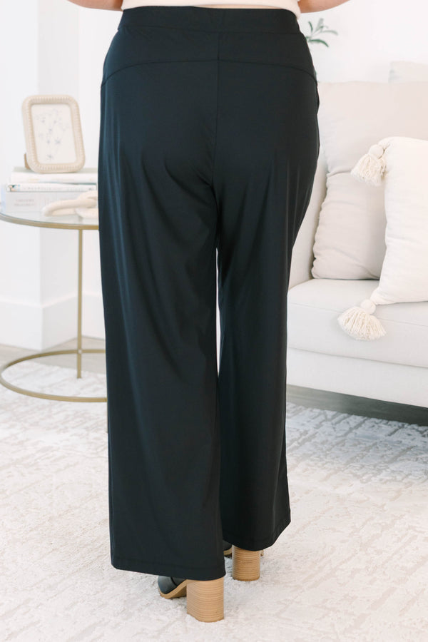 Plus size black wide-leg pants with a flowy fit and comfortable elastic waistband.