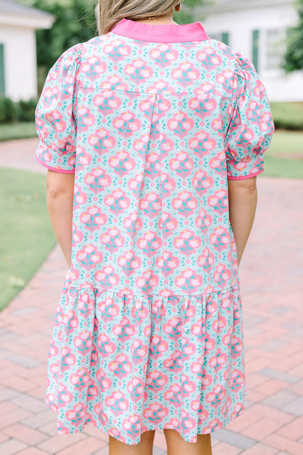 Plus Size pink and green floral print dress with a V-neckline, pink trim, and short puff sleeves.