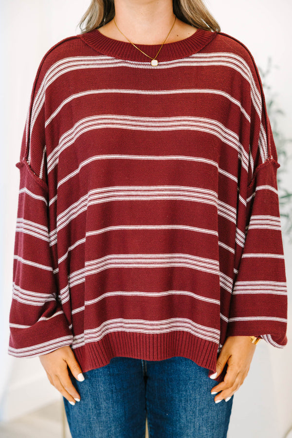 Plus Size burgundy and ivory striped drop shoulder sweater with exposed seams and a crew neckline.