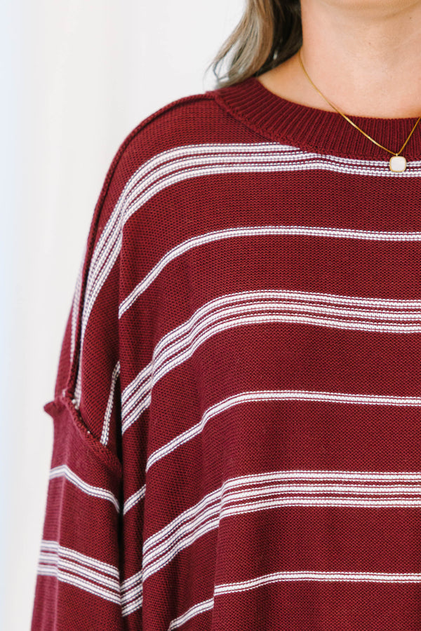Plus Size burgundy and ivory striped drop shoulder sweater with exposed seams and a crew neckline.