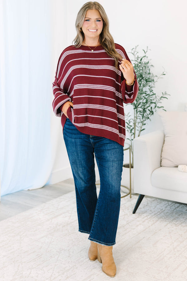 Plus Size burgundy and ivory striped drop shoulder sweater with exposed seams and a crew neckline.