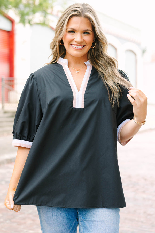 Plus Size black puff-sleeve top with a split v-neckline and cream and tan contrast trim.