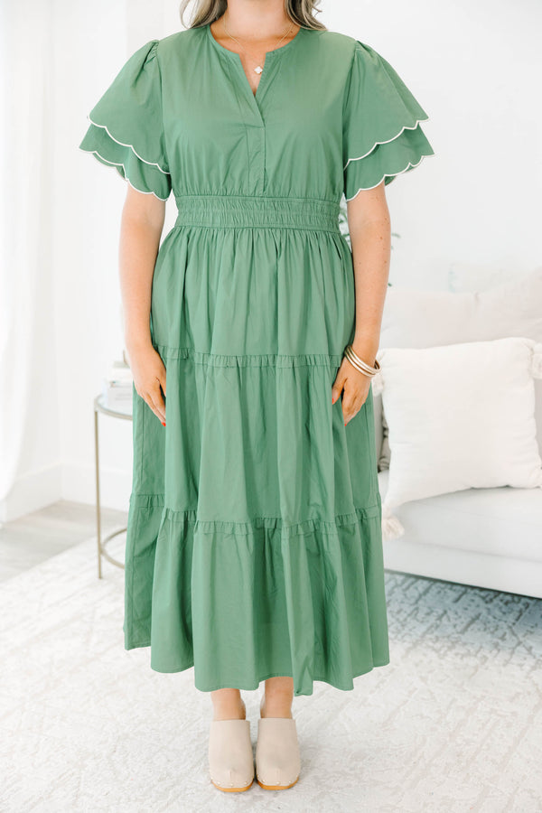 Plus Size olive tiered midi dress with a v-neckline, cinched waist, and scalloped white-piped sleeves.