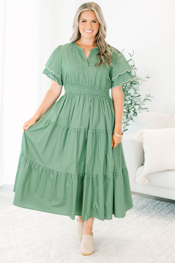 Plus Size olive tiered midi dress with a v-neckline, cinched waist, and scalloped white-piped sleeves.