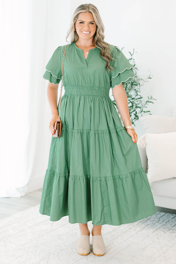 Plus Size olive tiered midi dress with a v-neckline, cinched waist, and scalloped white-piped sleeves.
