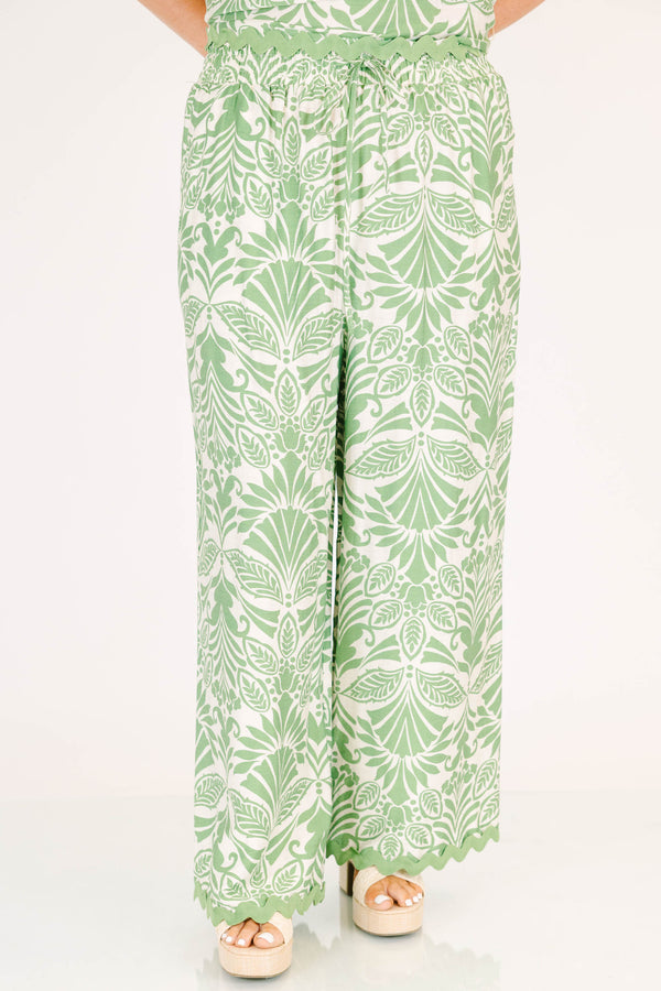 Chic Soul plus size clothing, green and white paisley patterned flowy pants with scalloped detailing along the bottom and an elastic waistband 