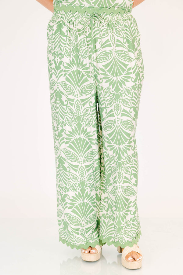 Chic Soul plus size clothing, green and white paisley patterned flowy pants with scalloped detailing along the bottom and an elastic waistband 