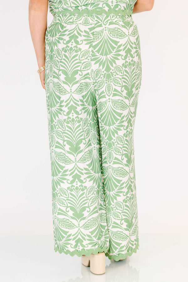 Chic Soul plus size clothing, green and white paisley patterned flowy pants with scalloped detailing along the bottom and an elastic waistband 