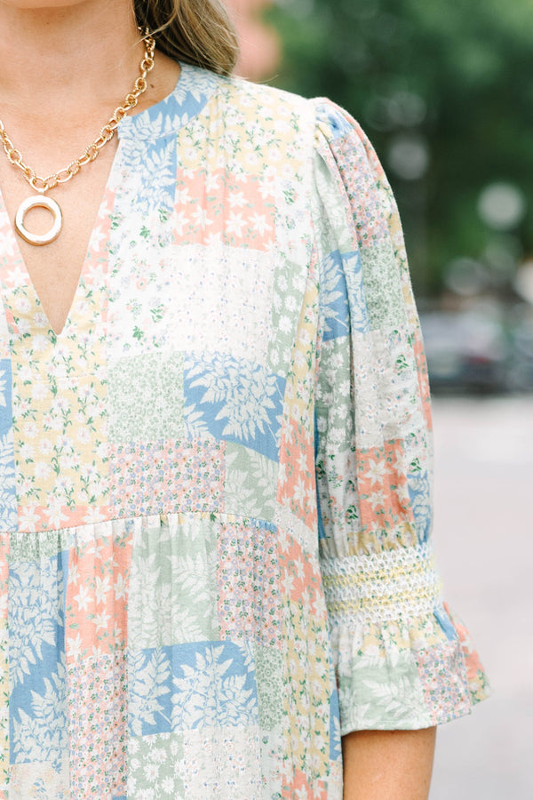 Plus size multi-color patchwork print midi dress with a flowy tiered skirt and v-neckline.