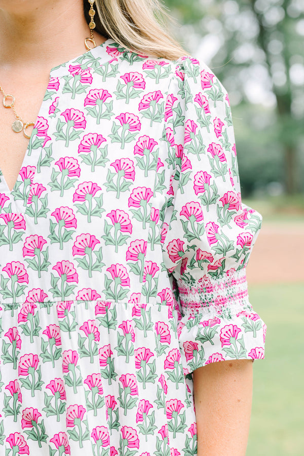 Plus Size pink floral tiered midi dress with puff sleeves and a V-neckline.