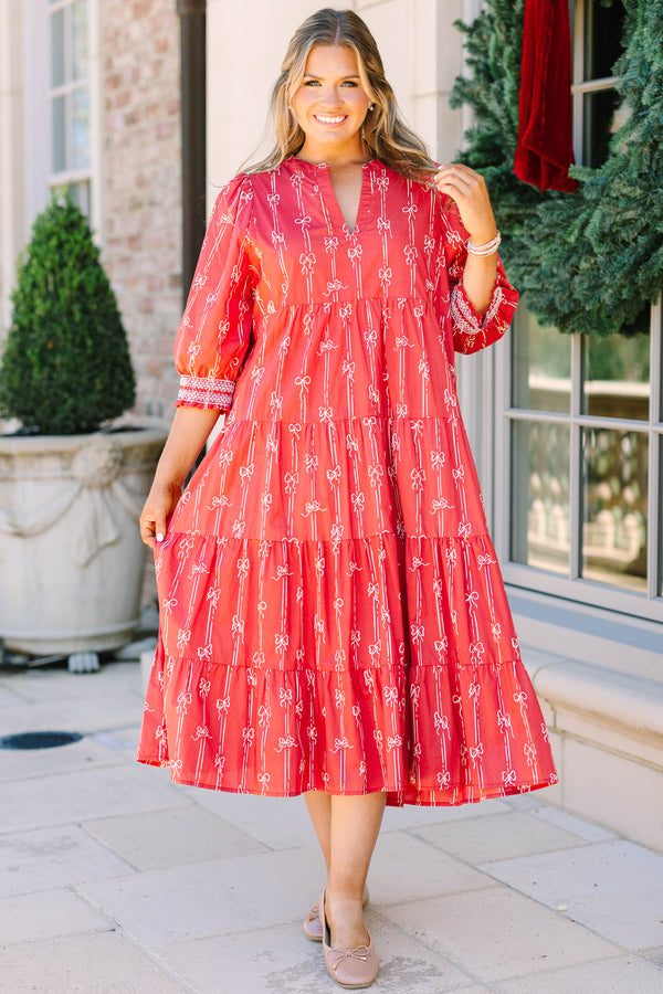 Plus size red bow print midi dress with a tiered skirt, v-neckline, and flowy cotton fit.