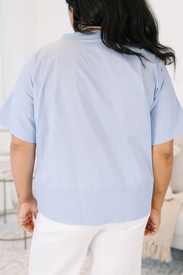 Plus size light blue cotton poplin button-down top with elbow-length sleeves.