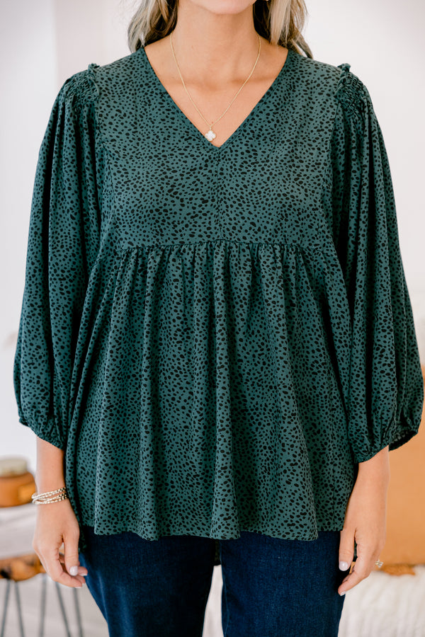 Chic Soul plus size clothing, dark green long top with three quarter inch sleeves and a black polka dot pattern throughout 
