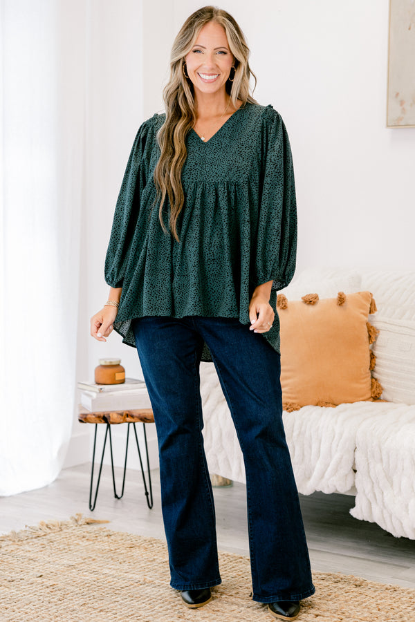 Chic Soul plus size clothing, dark green long top with three quarter inch sleeves and a black polka dot pattern throughout 
