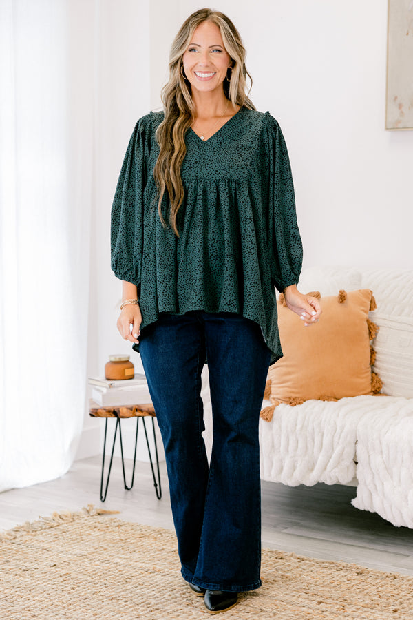 Chic Soul plus size clothing, dark green long top with three quarter inch sleeves and a black polka dot pattern throughout 
