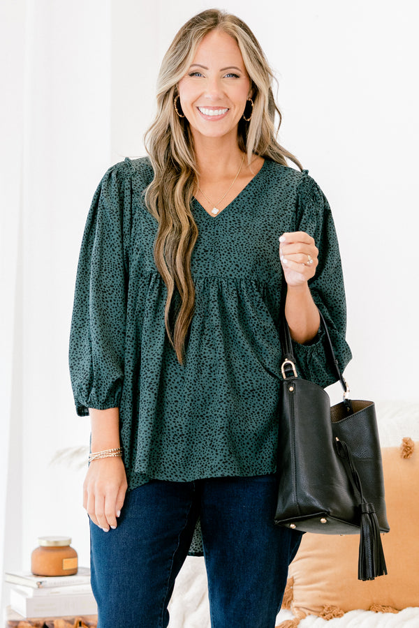 Chic Soul plus size clothing, dark green long top with three quarter inch sleeves and a black polka dot pattern throughout 
