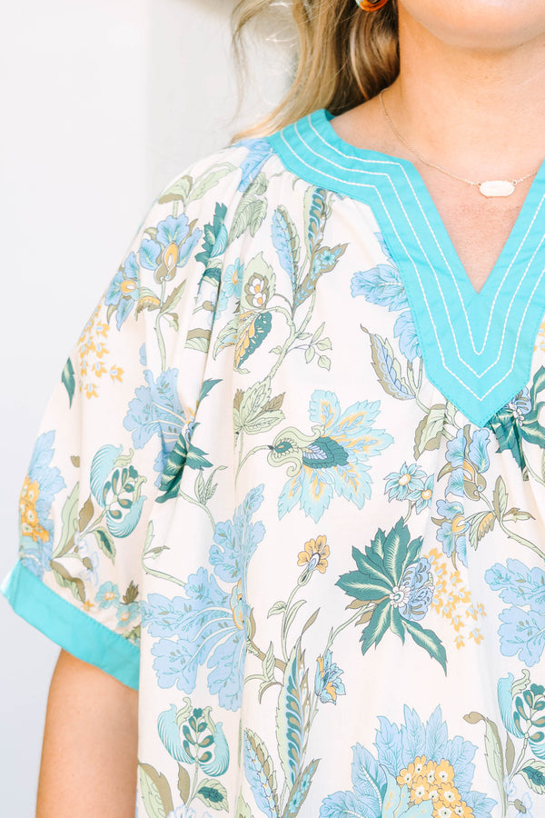 Plus size top in green floral cotton with a flowy fit and V-neckline.