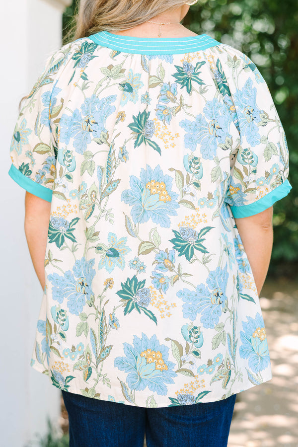Plus size top in green floral cotton with a flowy fit and V-neckline.